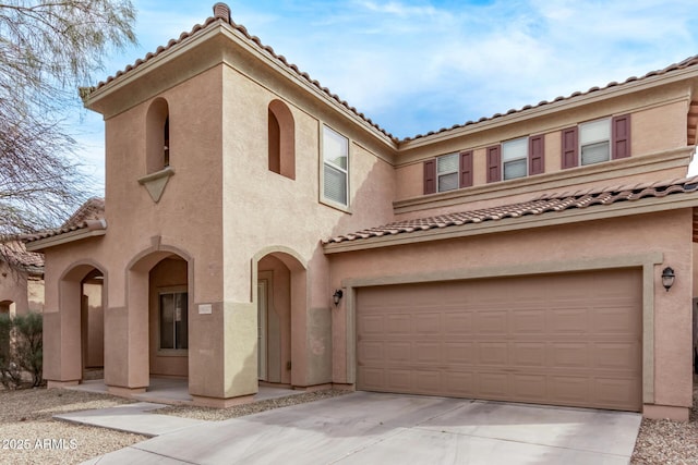 view of front of home with a garage, concrete driveway, and stucco siding