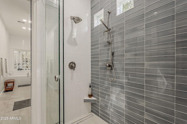 full bathroom featuring a shower stall, healthy amount of natural light, and tile patterned flooring