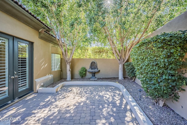 view of patio / terrace featuring french doors and a fenced backyard