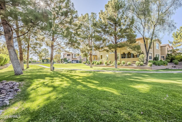 view of home's community with a yard and a residential view