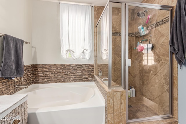 full bathroom featuring a bath and a shower stall