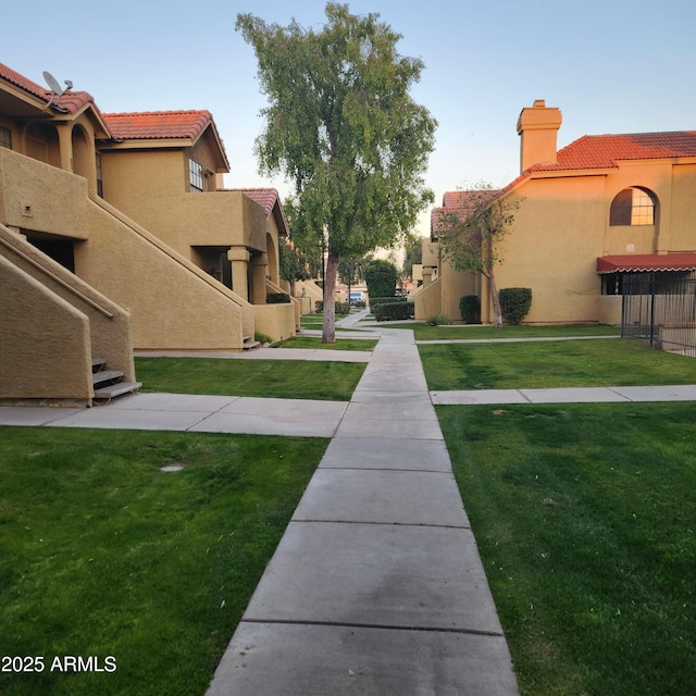 view of home's community with a yard