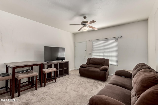 carpeted living room with ceiling fan