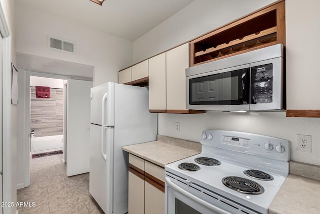 kitchen featuring white appliances and white cabinets