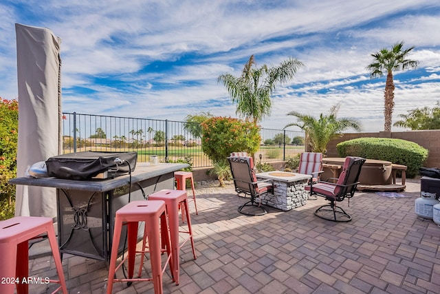 view of patio featuring a bar and an outdoor fire pit