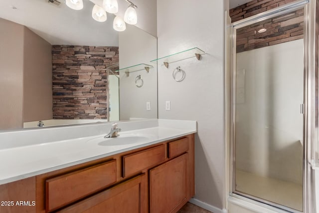 bathroom featuring a shower stall and vanity