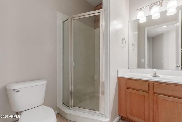 full bathroom featuring toilet, a shower stall, vanity, and baseboards