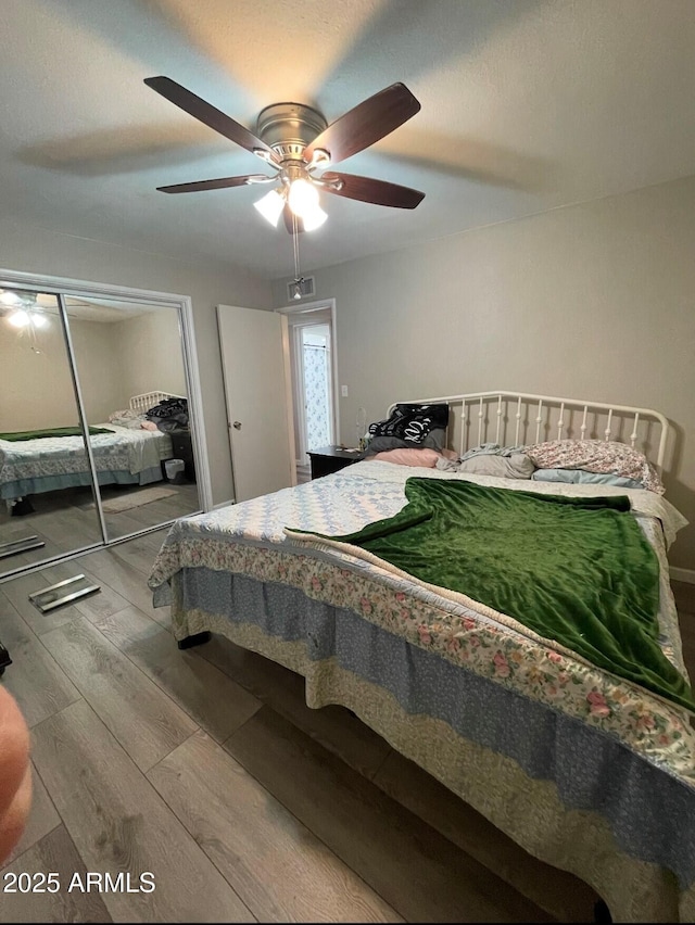 bedroom featuring a closet, ceiling fan, and hardwood / wood-style floors