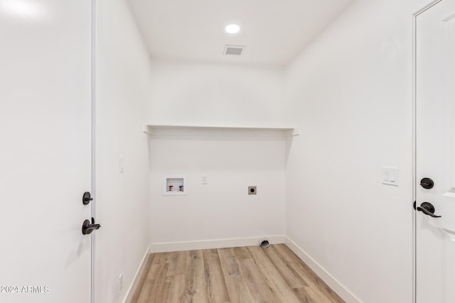 laundry area featuring hookup for an electric dryer, light hardwood / wood-style floors, and hookup for a washing machine