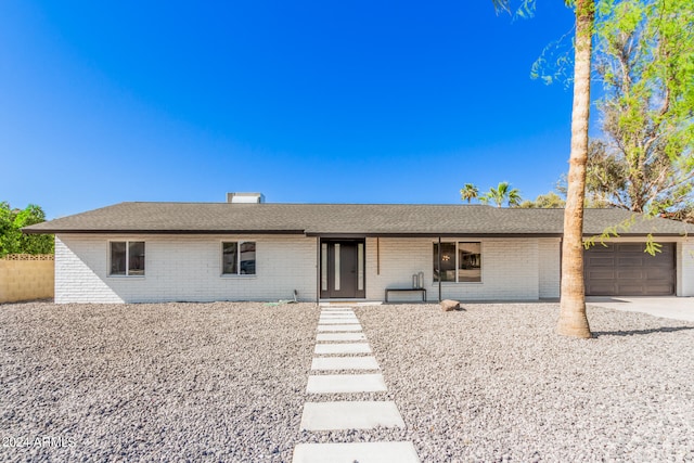 ranch-style home featuring a garage