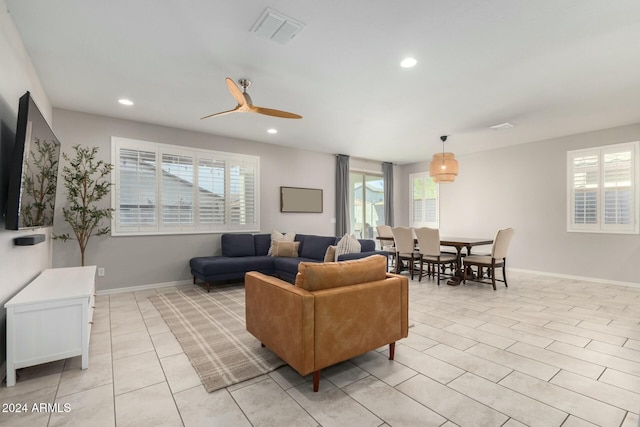 living room with ceiling fan and light tile patterned flooring