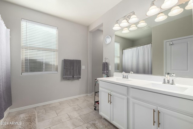 bathroom featuring tile patterned flooring and vanity