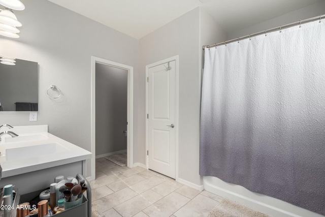 bathroom featuring tile patterned flooring, shower / tub combo, and vanity