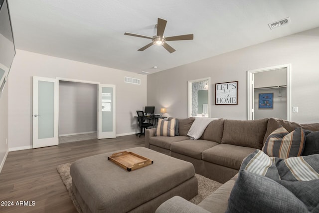 living room featuring ceiling fan, french doors, and dark wood-type flooring