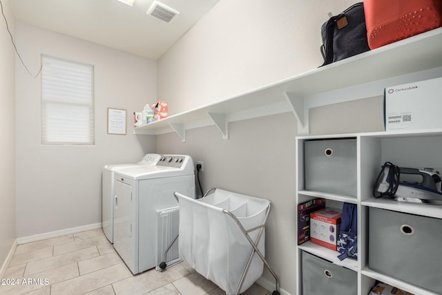 washroom with washing machine and dryer and light tile patterned floors