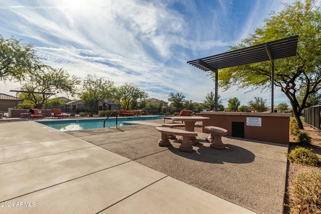 view of pool with a pergola and a patio