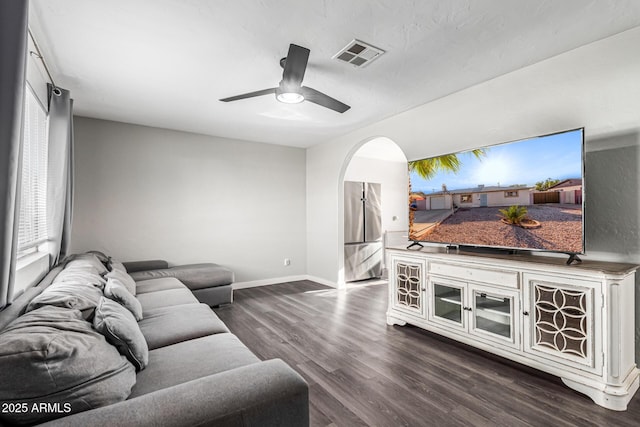 4408 N 29th Ave, Phoenix, AZ 85017 - living area featuring dark wood finished floors, arched walkways, baseboards, and ceiling fan