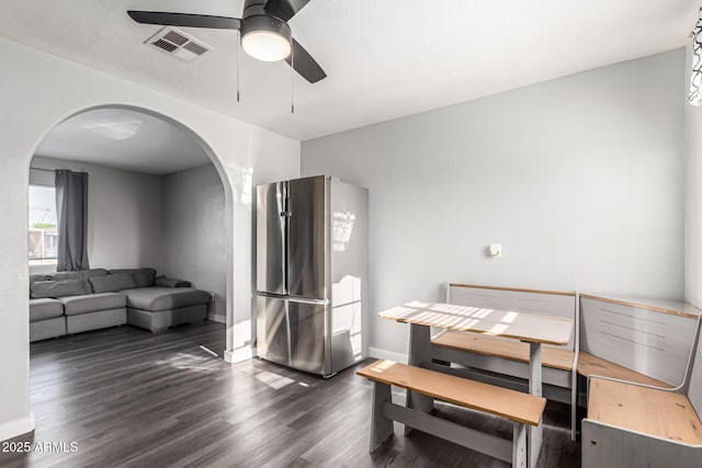 4408 N 29th Ave, Phoenix, AZ 85017 - dining space with arched walkways, a ceiling fan, dark wood-type flooring, and baseboards