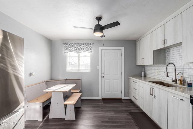 4408 N 29th Ave, Phoenix, AZ 85017 - kitchen with a sink, ceiling fan, tasteful backsplash, light countertops, and dark wood-style floors