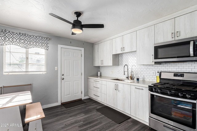 4408 N 29th Ave, Phoenix, AZ 85017 - kitchen featuring stainless steel appliances, a sink, a ceiling fan, light countertops, and tasteful backsplash