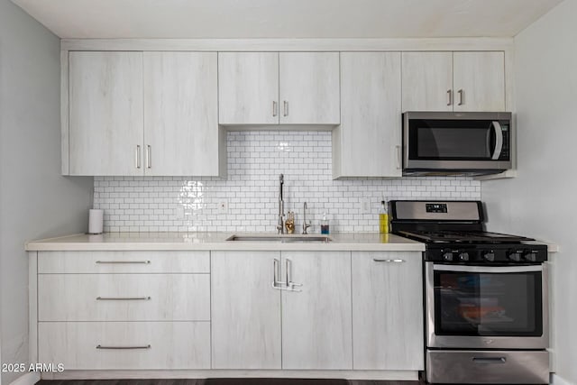 4408 N 29th Ave, Phoenix, AZ 85017 - kitchen featuring appliances with stainless steel finishes, a sink, light countertops, decorative backsplash, and light brown cabinetry