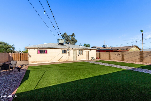 4408 N 29th Ave, Phoenix, AZ 85017 - rear view of house featuring a patio, stucco siding, and an outdoor fire pit