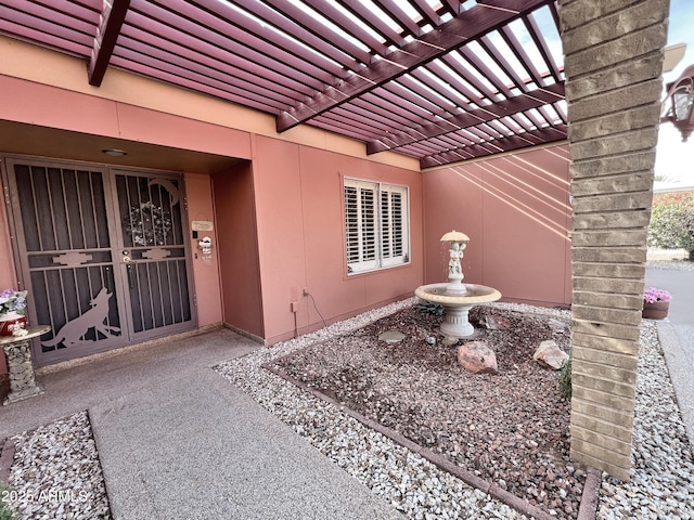 doorway to property featuring a pergola