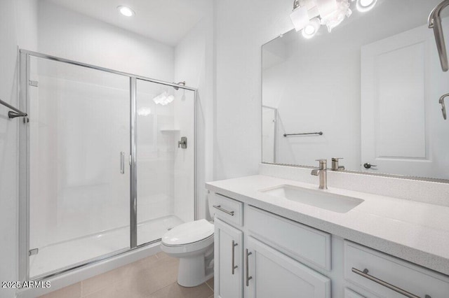 bathroom featuring toilet, tile patterned floors, a shower stall, and vanity