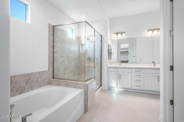 bathroom featuring a sink, double vanity, a shower stall, and a bath