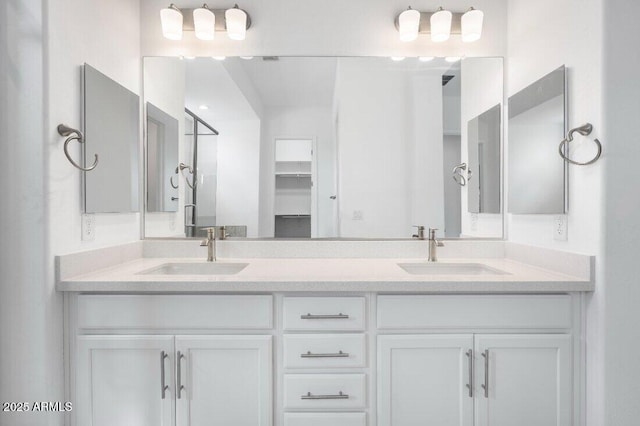 bathroom with a sink and double vanity