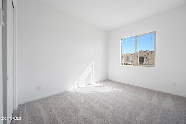 empty room with carpet floors and baseboards