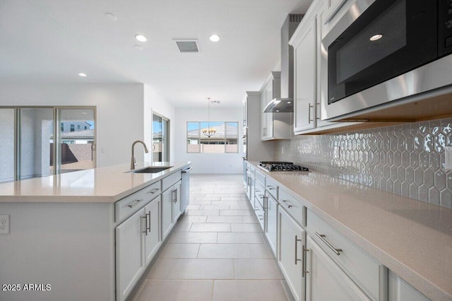 kitchen featuring white cabinets, visible vents, stainless steel appliances, and light countertops