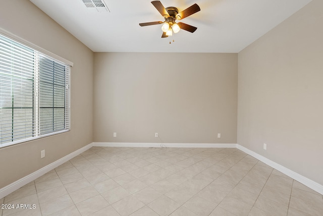 unfurnished room featuring ceiling fan and light tile patterned flooring