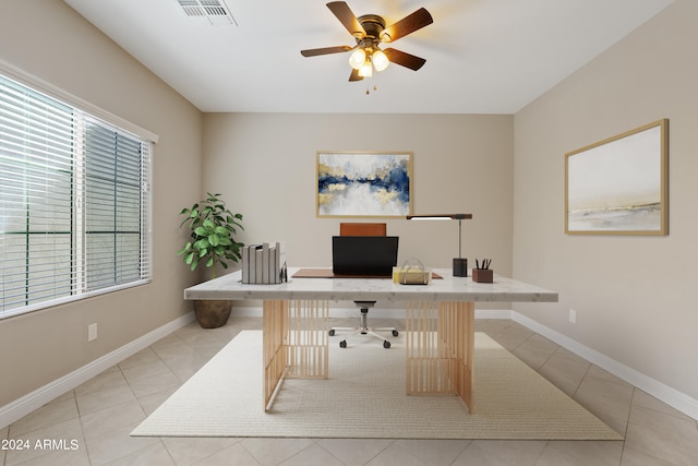 tiled home office featuring ceiling fan