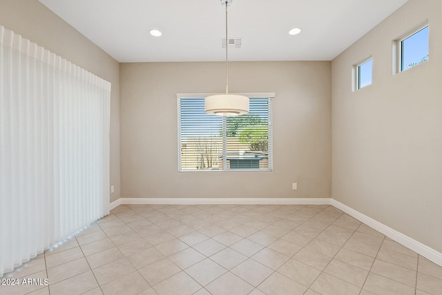 tiled empty room with a wealth of natural light