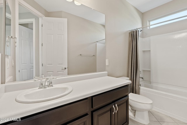 full bathroom with toilet, vanity, shower / bath combo with shower curtain, and tile patterned floors