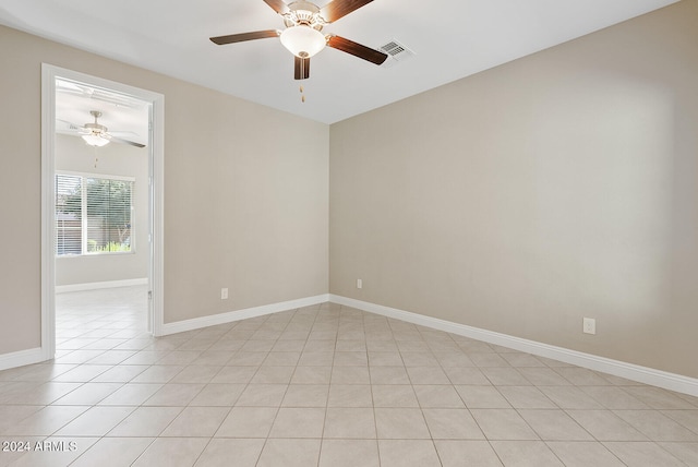 unfurnished room featuring ceiling fan and light tile patterned floors