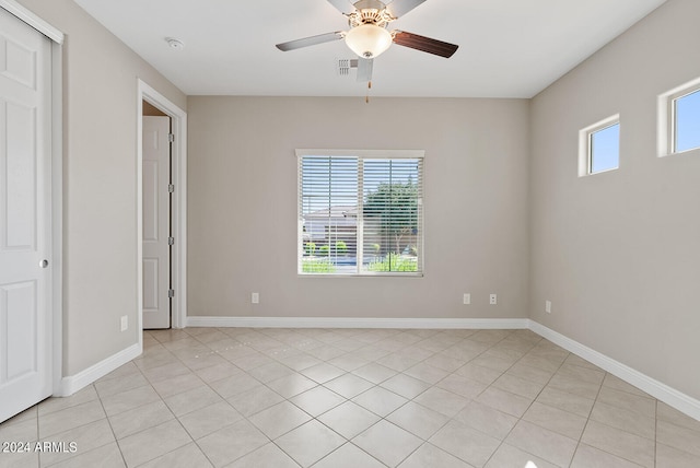 unfurnished bedroom with ceiling fan and light tile patterned flooring