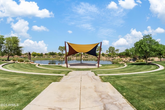 view of home's community featuring a water view and a lawn