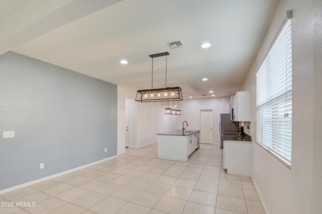 kitchen featuring light tile patterned floors, visible vents, dark countertops, white cabinetry, and recessed lighting