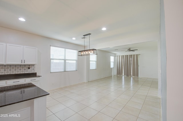 unfurnished dining area featuring light tile patterned floors, a ceiling fan, and recessed lighting