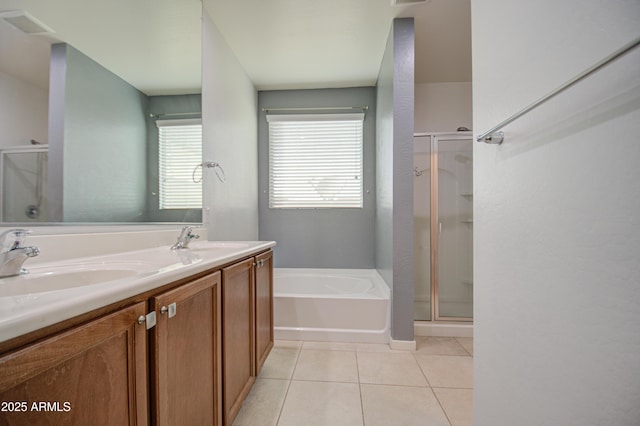 full bath with tile patterned flooring, a garden tub, a sink, and a shower stall