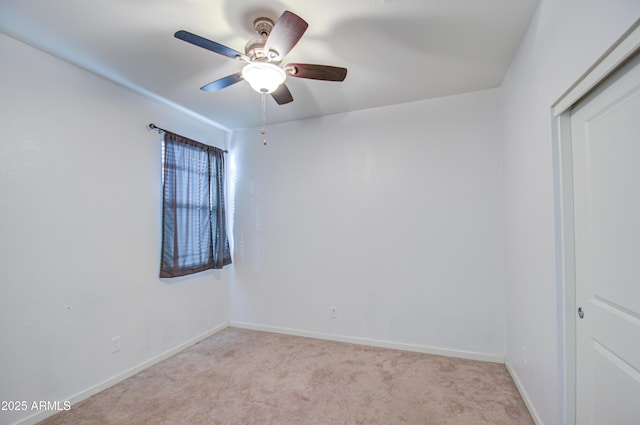 empty room with light carpet, baseboards, and a ceiling fan