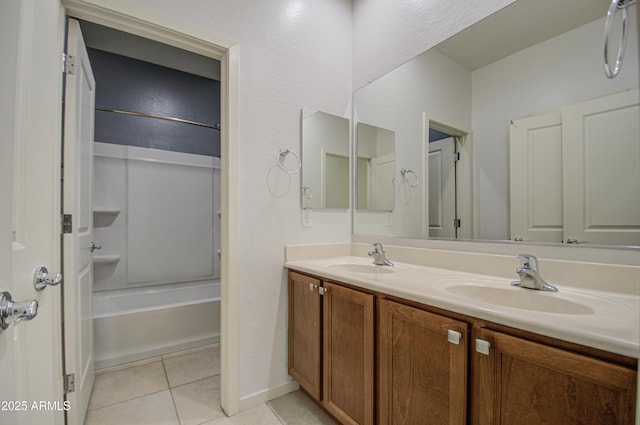 bathroom with washtub / shower combination, tile patterned flooring, a sink, and double vanity