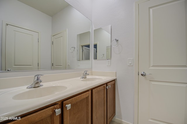 bathroom featuring double vanity and a sink