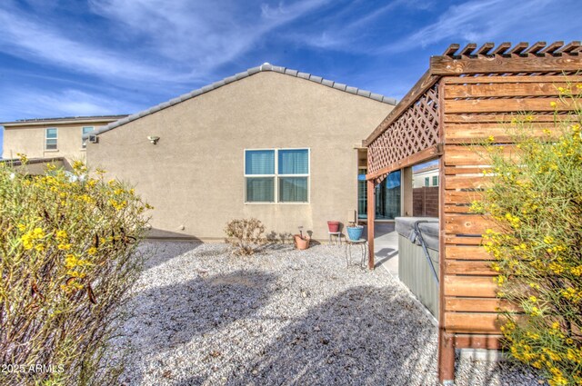 exterior space featuring a patio area and stucco siding