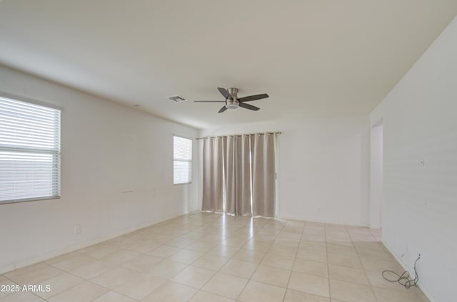 unfurnished room featuring light tile patterned floors, visible vents, and a ceiling fan