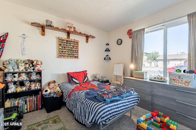 bedroom with carpet floors and a textured ceiling