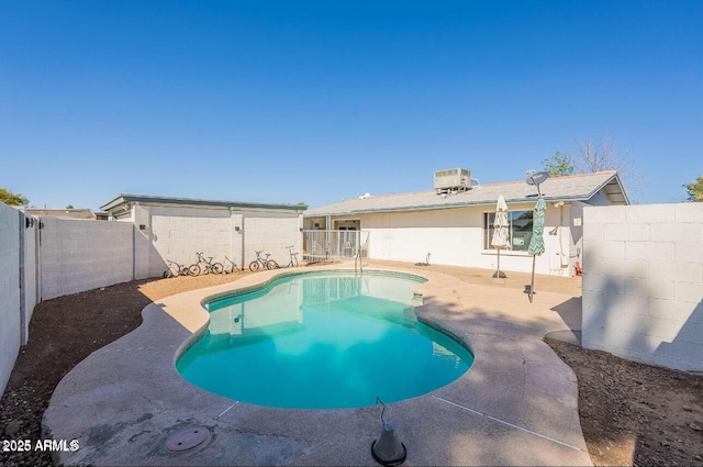 view of pool with a fenced backyard, central air condition unit, and a patio