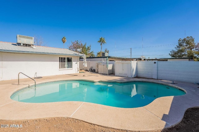 view of swimming pool with a patio area, central air condition unit, and a fenced backyard